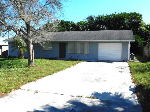 ranch-style house featuring a garage and a front yard