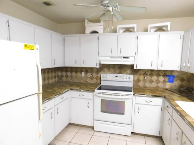 kitchen featuring light tile patterned floors, white appliances, decorative backsplash, and white cabinets