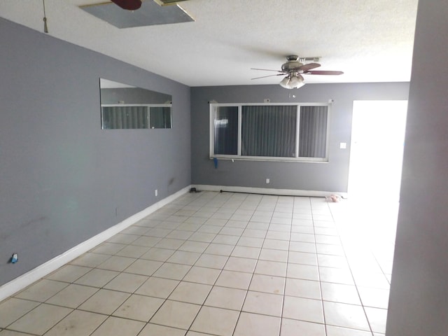 tiled spare room featuring ceiling fan and a textured ceiling