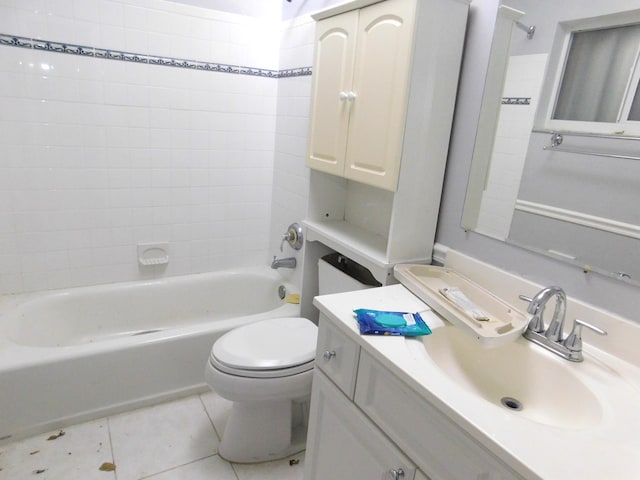 full bathroom featuring vanity, tiled shower / bath, tile patterned floors, and toilet