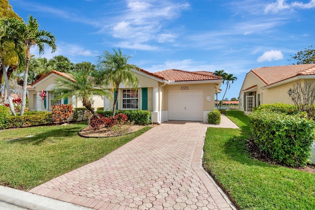 view of front of home with a garage, a front yard, decorative driveway, and stucco siding