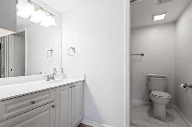 bathroom featuring vanity and toilet