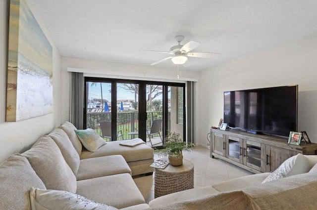 tiled living room featuring ceiling fan