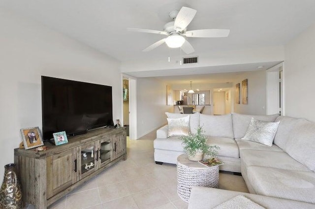 tiled living room with ceiling fan