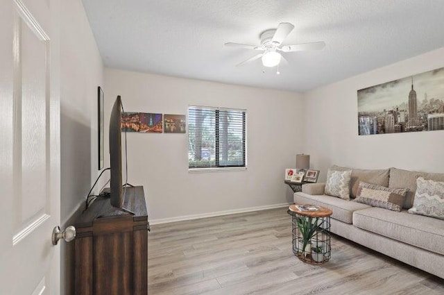 living room featuring ceiling fan and light hardwood / wood-style flooring