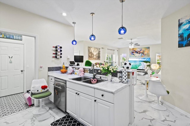 kitchen with sink, white cabinetry, decorative light fixtures, dishwasher, and ceiling fan