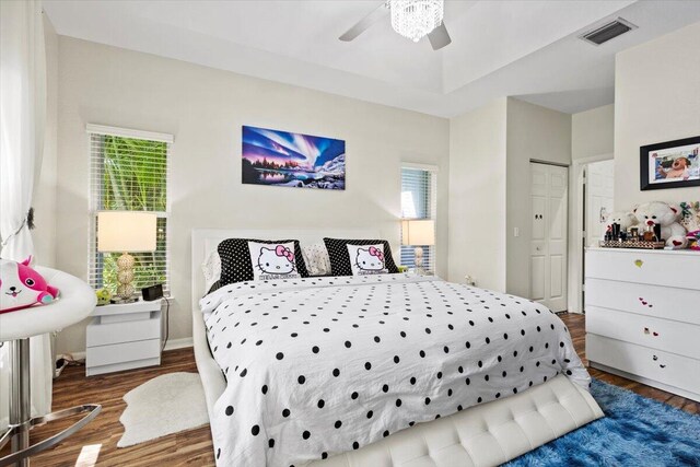 bedroom with wood-type flooring, a closet, and ceiling fan