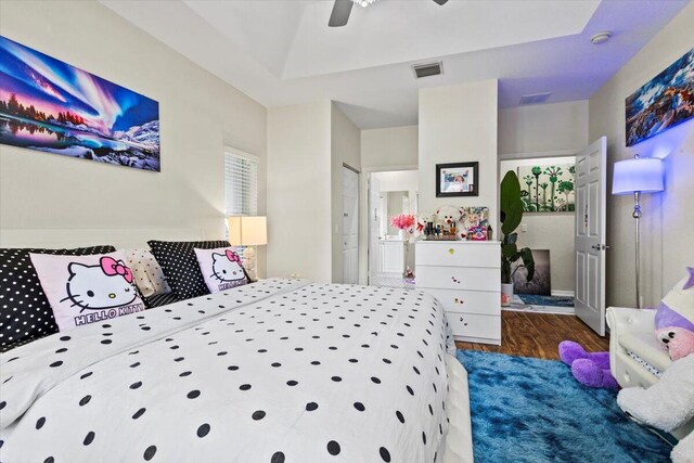 bedroom featuring ceiling fan, dark hardwood / wood-style flooring, and ensuite bath