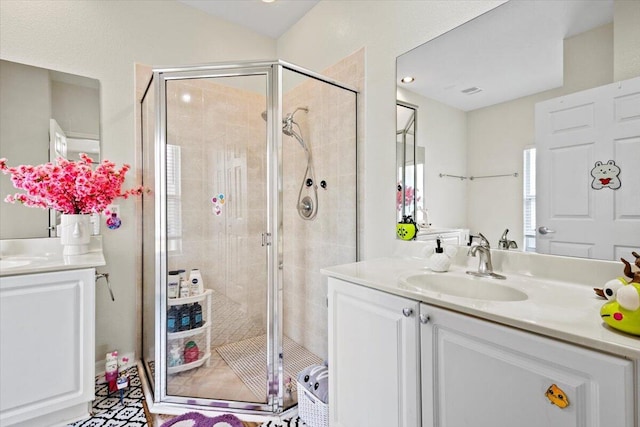 bathroom featuring vanity and an enclosed shower