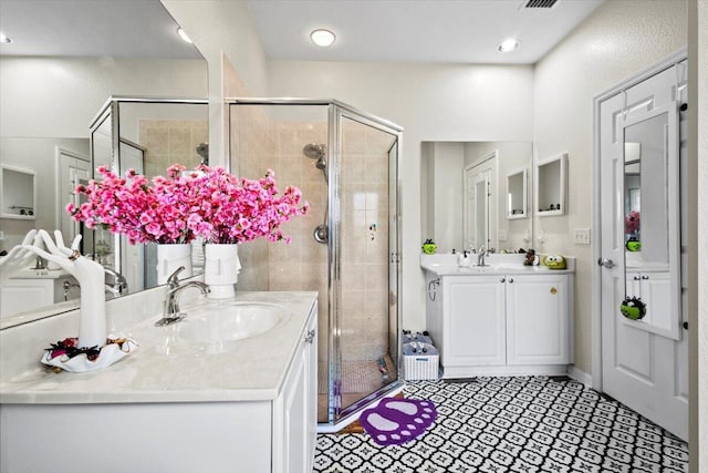 bathroom with a shower with door and vanity