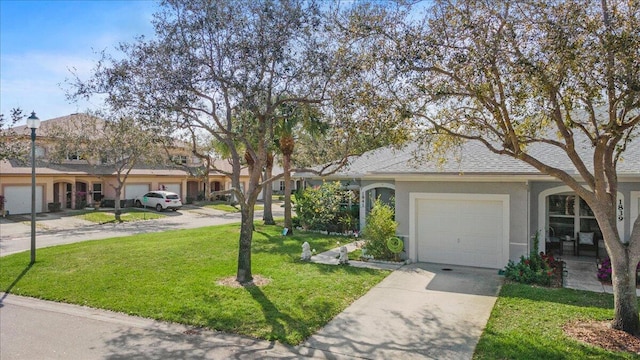 ranch-style home with a garage and a front yard