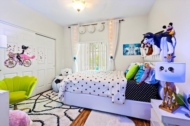 bedroom featuring hardwood / wood-style floors and a closet