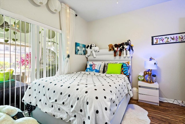 bedroom featuring access to outside and dark hardwood / wood-style floors