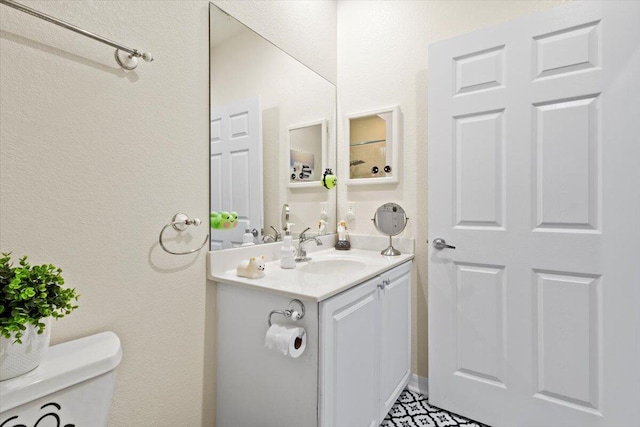 bathroom with vanity and toilet