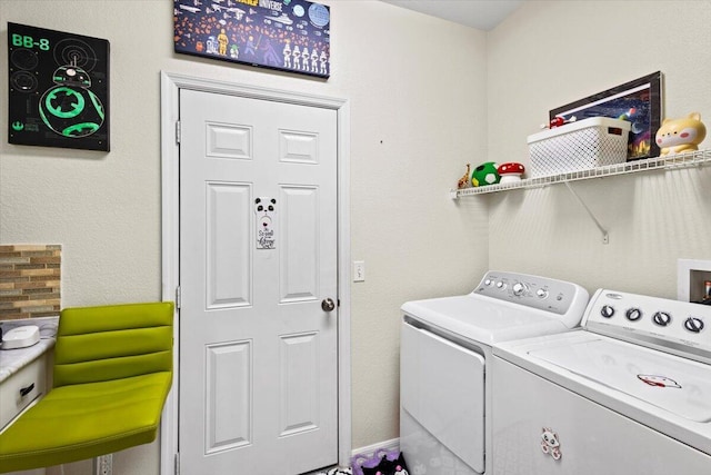 washroom featuring washer and clothes dryer