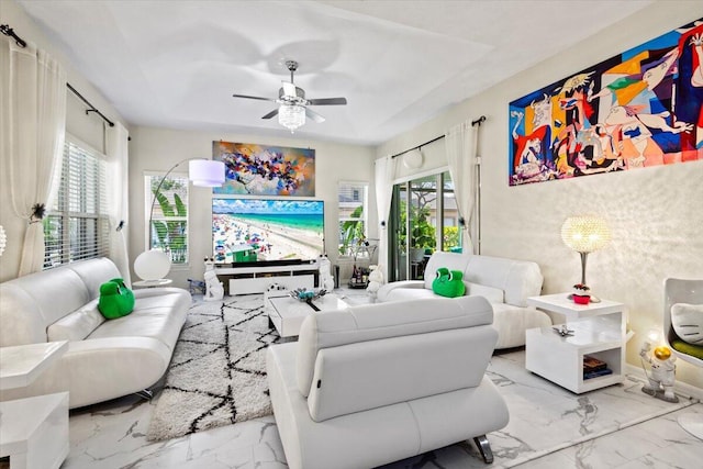 living room featuring a healthy amount of sunlight and ceiling fan