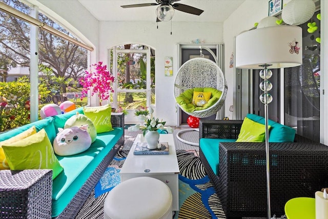 sunroom featuring ceiling fan