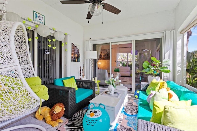 sunroom featuring ceiling fan