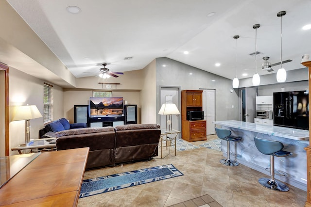 living room featuring light tile patterned flooring, lofted ceiling, and ceiling fan