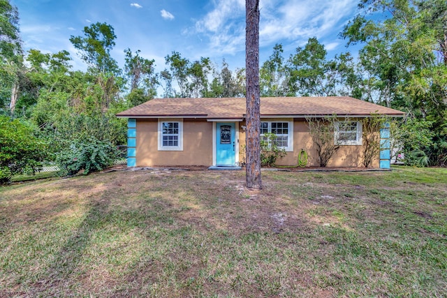 ranch-style home featuring a front yard