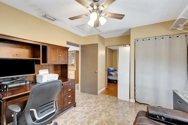 office with ceiling fan and a textured ceiling