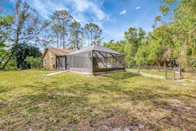 view of yard with glass enclosure