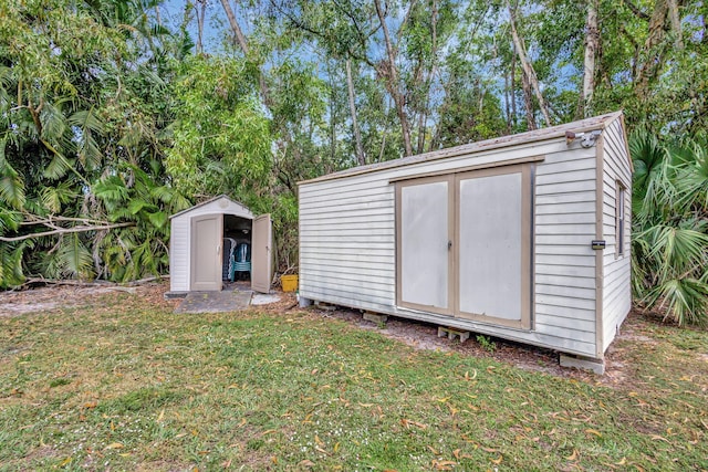 view of outbuilding with a lawn