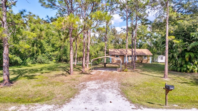 view of front facade with a front yard and a carport