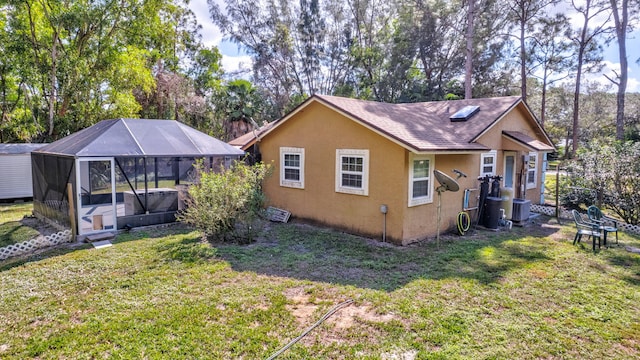 view of side of home with a lawn and central air condition unit