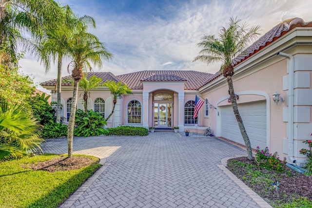 mediterranean / spanish-style home with a garage