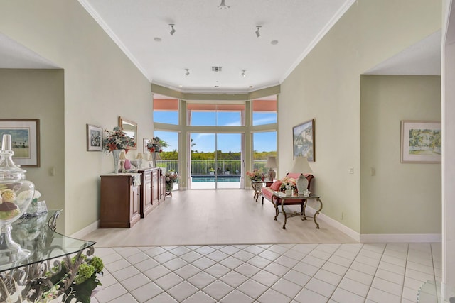 entryway featuring light tile patterned floors, ornamental molding, and a high ceiling