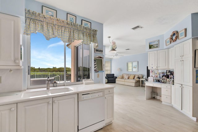 kitchen with sink, white cabinets, ceiling fan, white dishwasher, and light hardwood / wood-style flooring