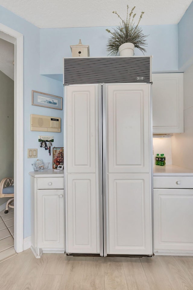 interior space featuring hardwood / wood-style flooring and paneled built in fridge