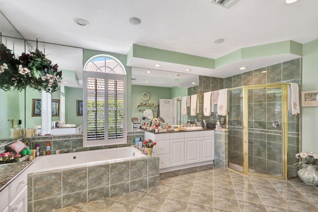 bathroom featuring vanity and plus walk in shower