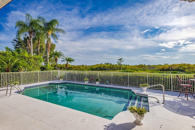 view of swimming pool featuring a patio area