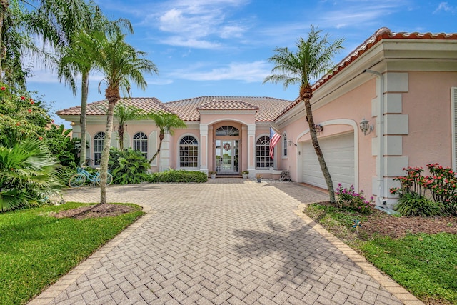 mediterranean / spanish-style home featuring a garage