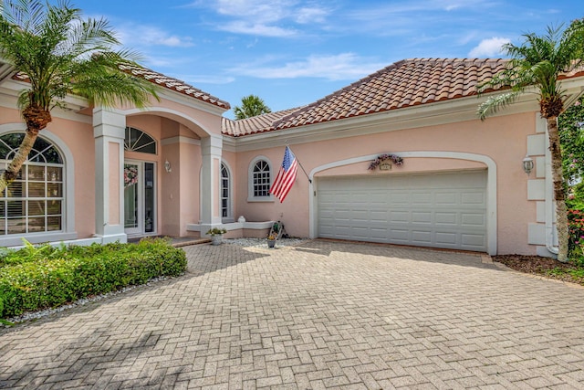 mediterranean / spanish-style home featuring a garage