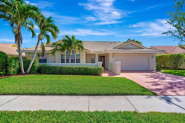 ranch-style home with a garage and a front yard