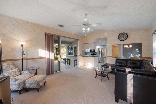 carpeted living room featuring ceiling fan, vaulted ceiling, and a textured ceiling