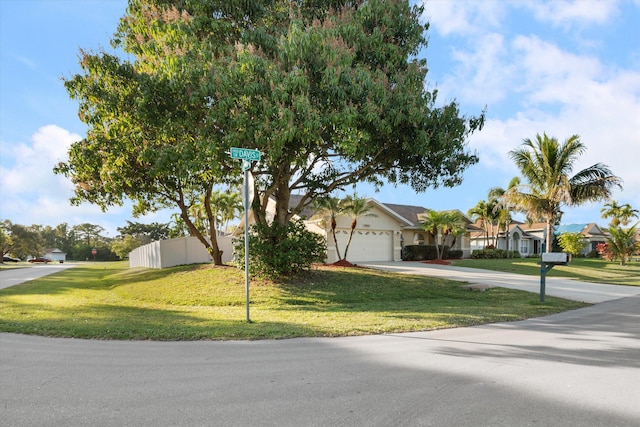 view of front of house featuring a garage and a front lawn