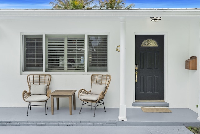 view of exterior entry with covered porch