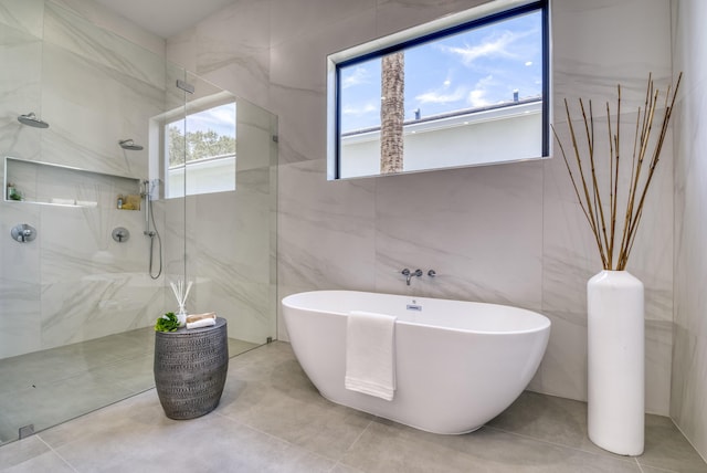 bathroom featuring tile walls, tile patterned floors, and independent shower and bath