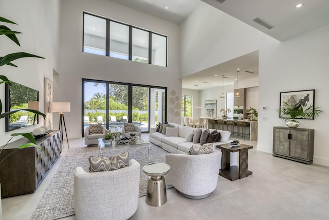 living room featuring a towering ceiling