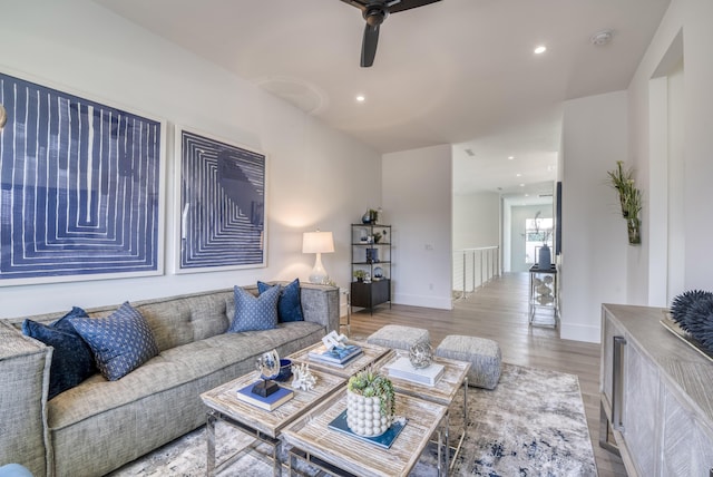 living room with ceiling fan and light hardwood / wood-style floors