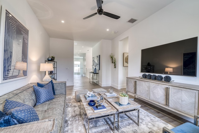 living room featuring hardwood / wood-style flooring and ceiling fan