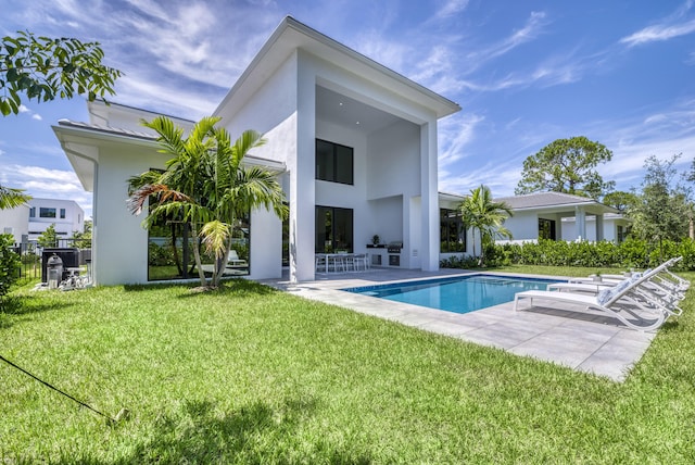 rear view of house featuring a lawn and a patio area