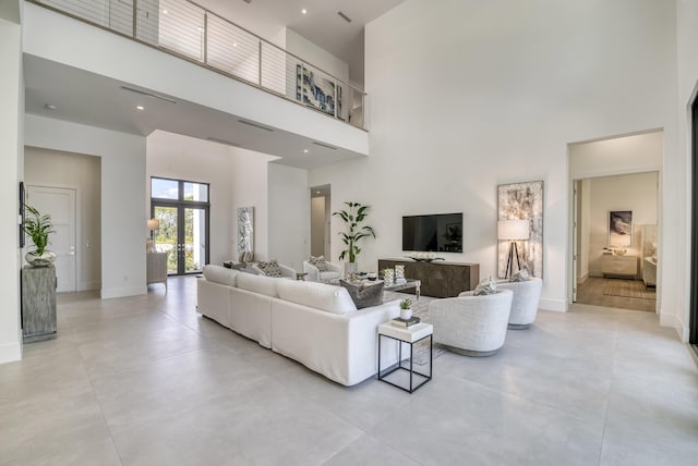 living room with a towering ceiling and french doors