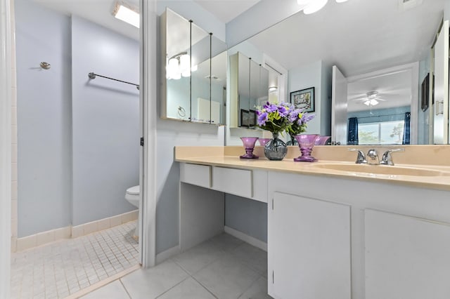 bathroom with toilet, ceiling fan, vanity, tile patterned flooring, and baseboards