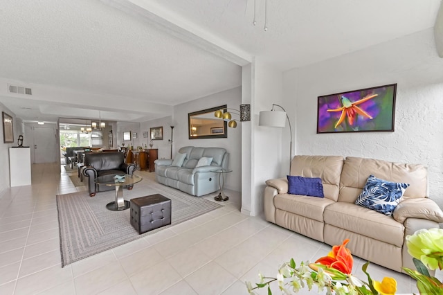 living area with visible vents, a textured ceiling, and tile patterned floors