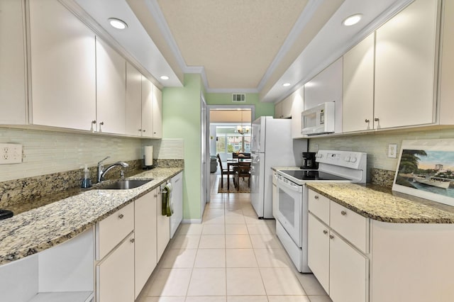 kitchen with ornamental molding, white appliances, white cabinetry, and light tile patterned floors